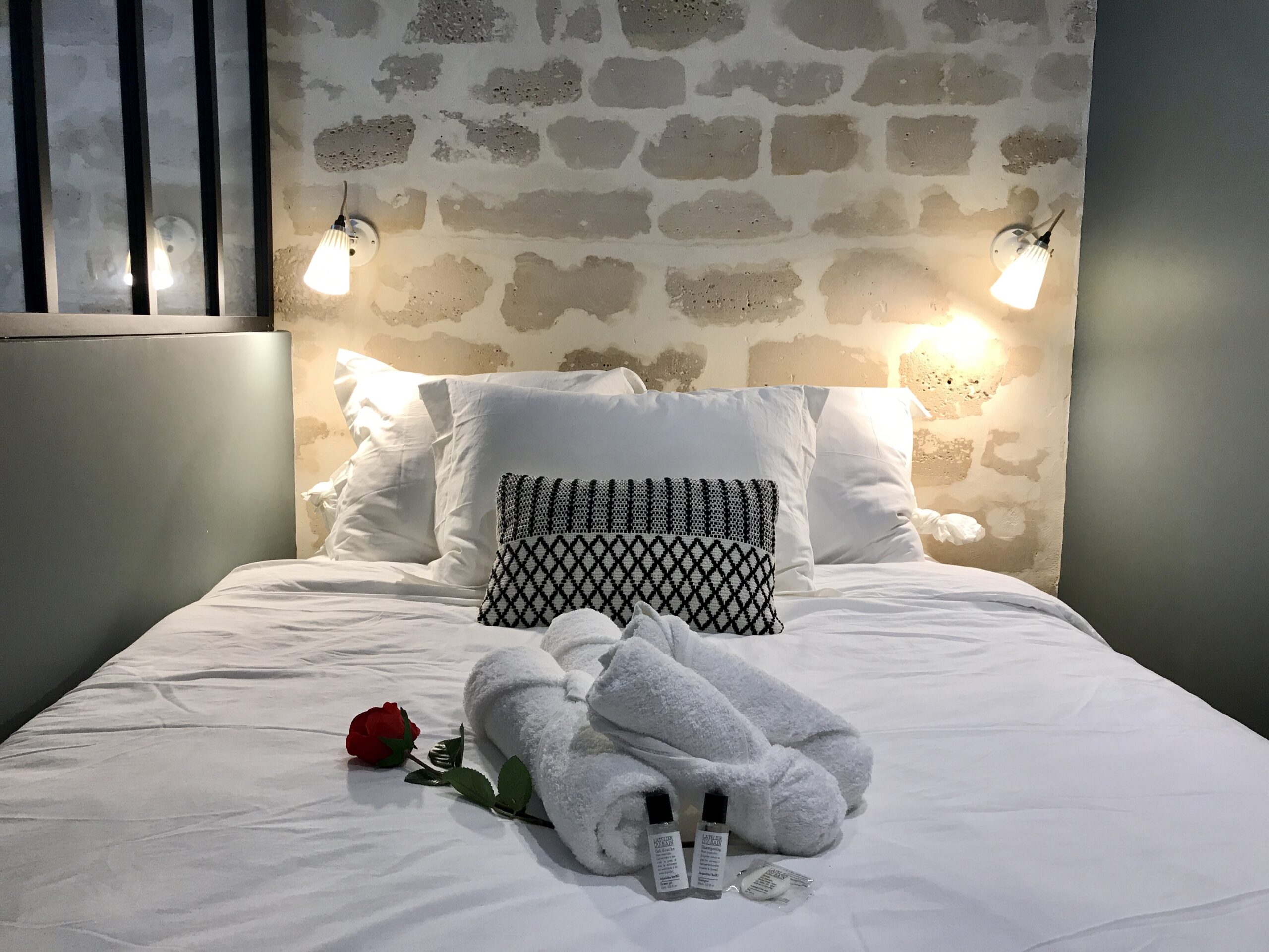 Elegant bedroom with soft lighting and luxury linens in a Paris apartment