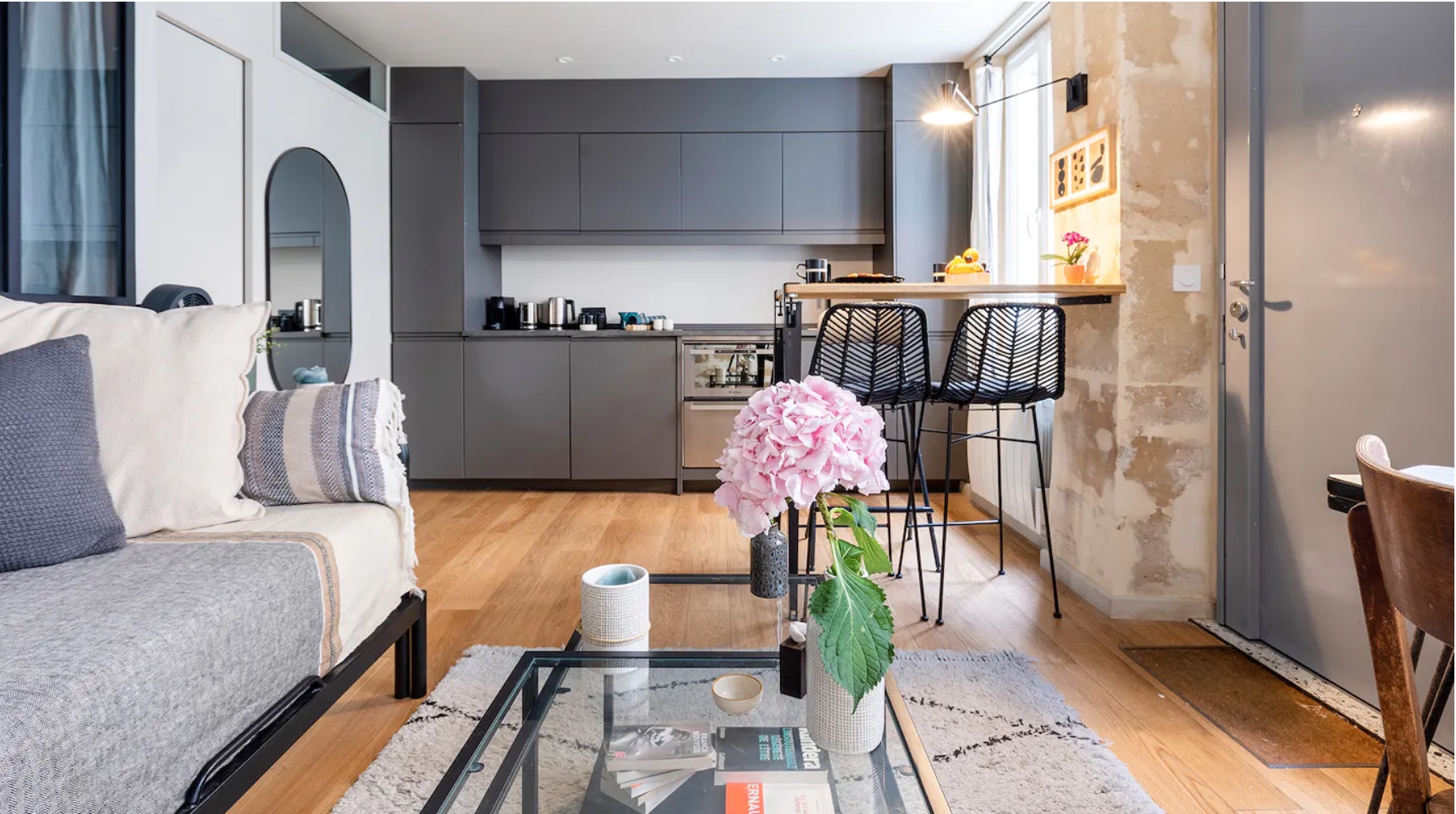 Contemporary kitchen and living room in a Parisian luxury rental.