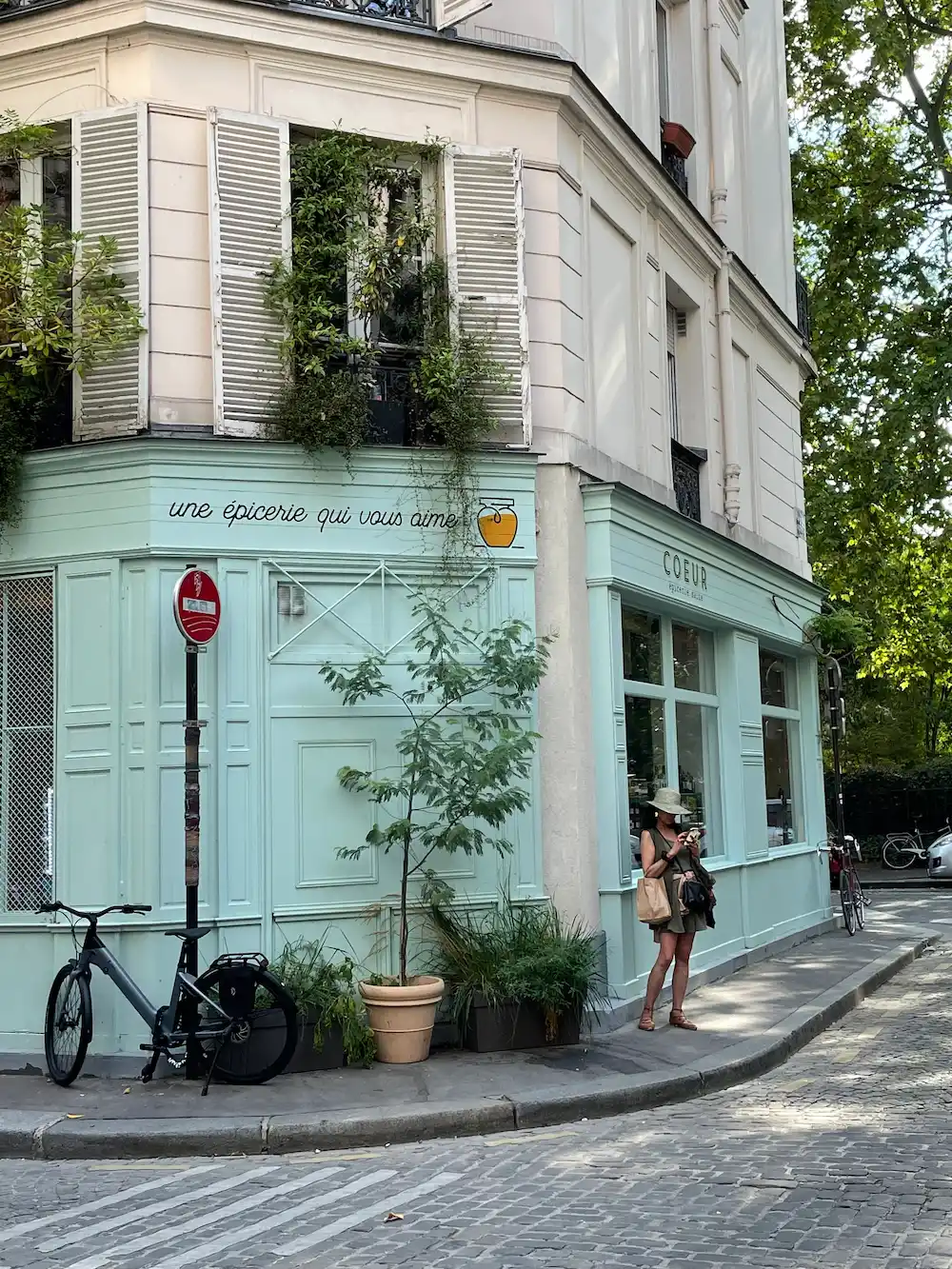 Charming corner grocery with mint facade in Paris 11 near the apartment