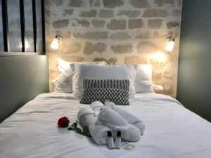 Cozy double bed with fresh towels and toiletries at L’Atelier Dupont in Paris 11